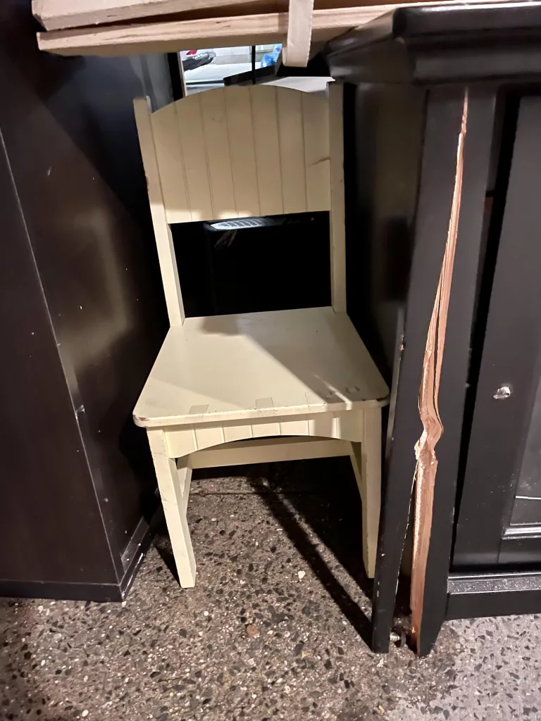 Discarded hidden chair in New York City.