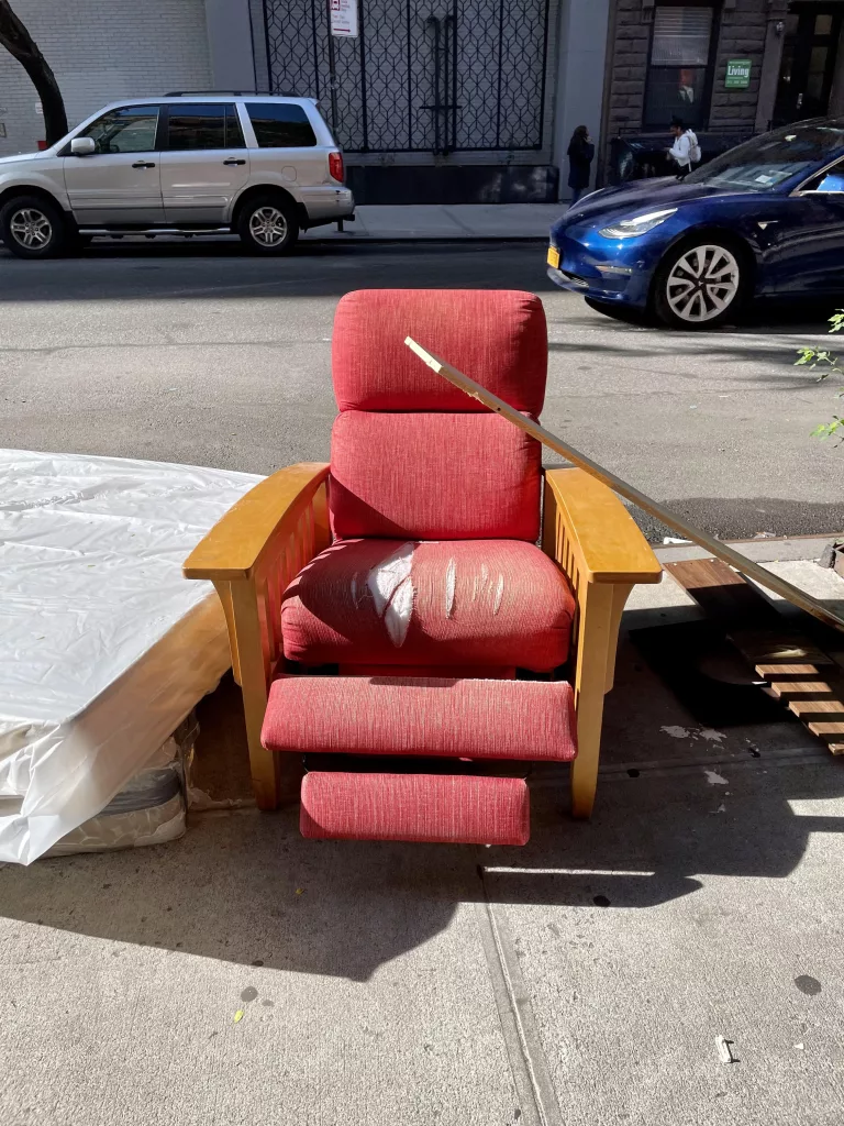 Discarded reclining chair in New York City. 