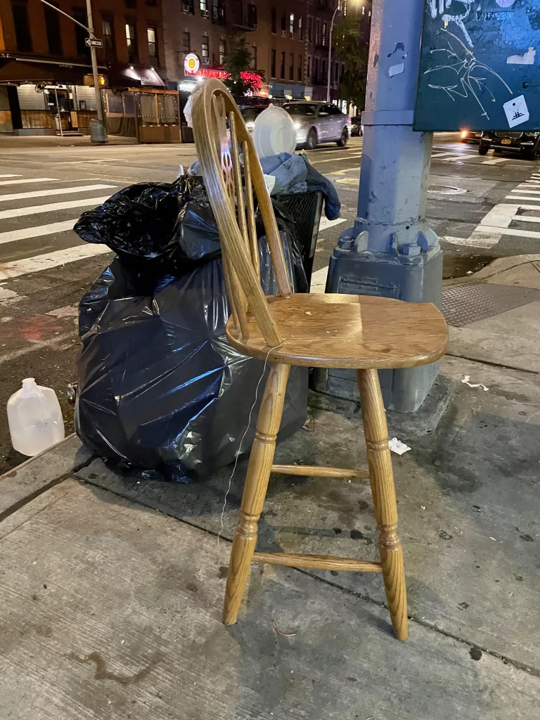 Discarded wooden chair in New York City.