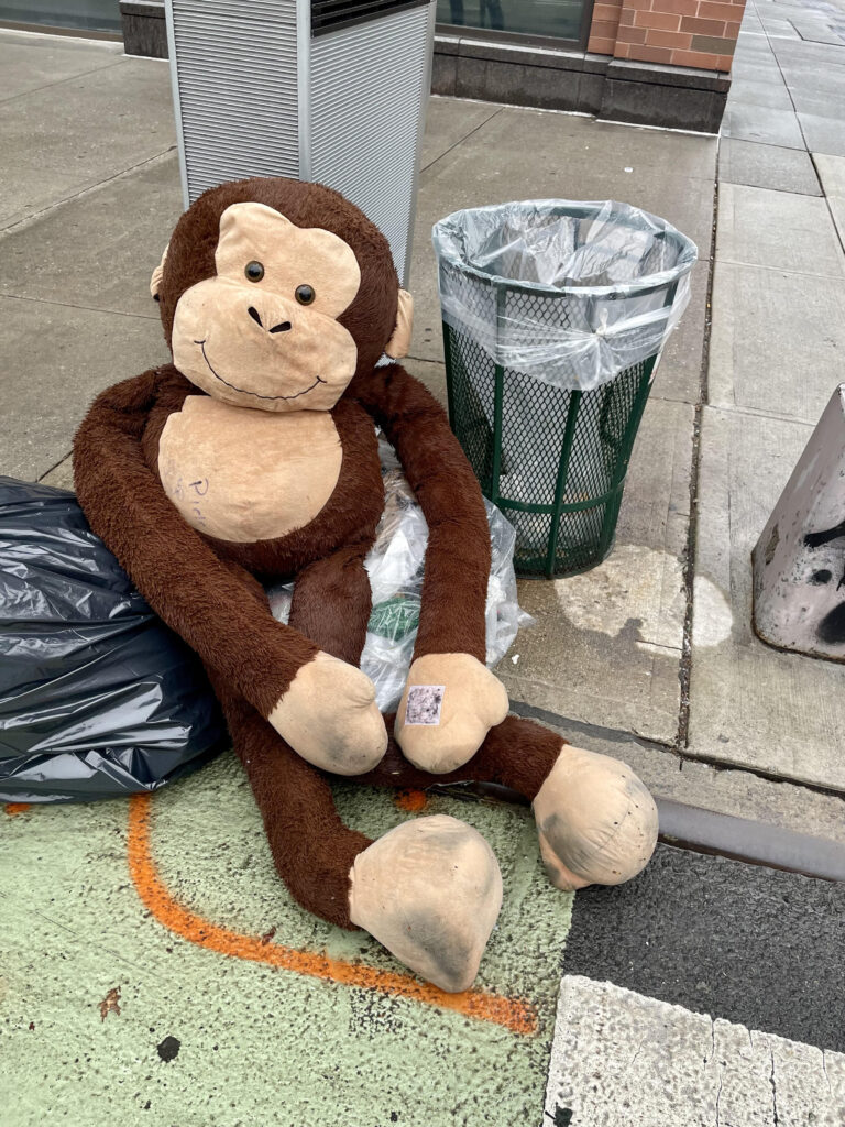 Stuffed monkey on New York City sidewalk