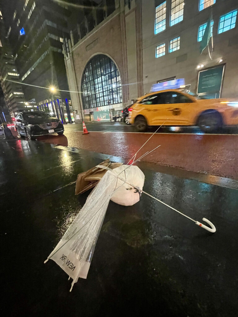 Broken NYC umbrella on a rainy night.