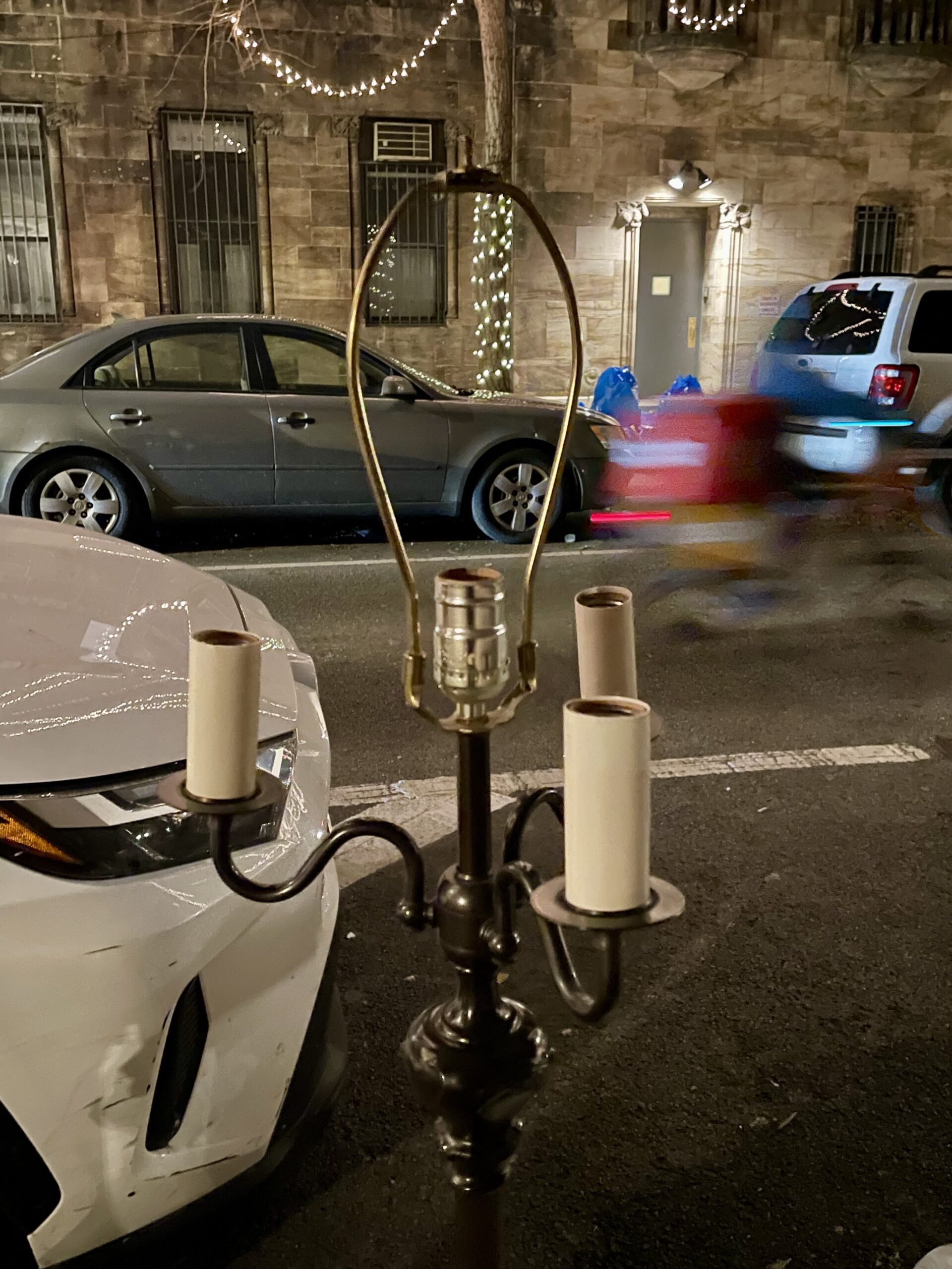 Abandoned lamp of 55th Street under holiday lights.